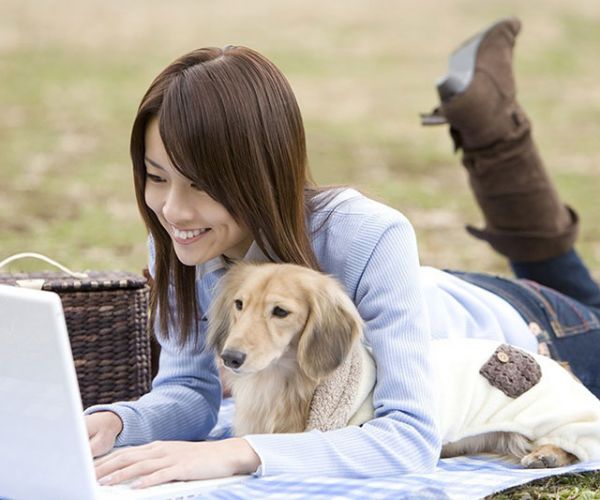 Woman with dog and laptop