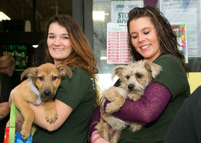 Women holding dogs