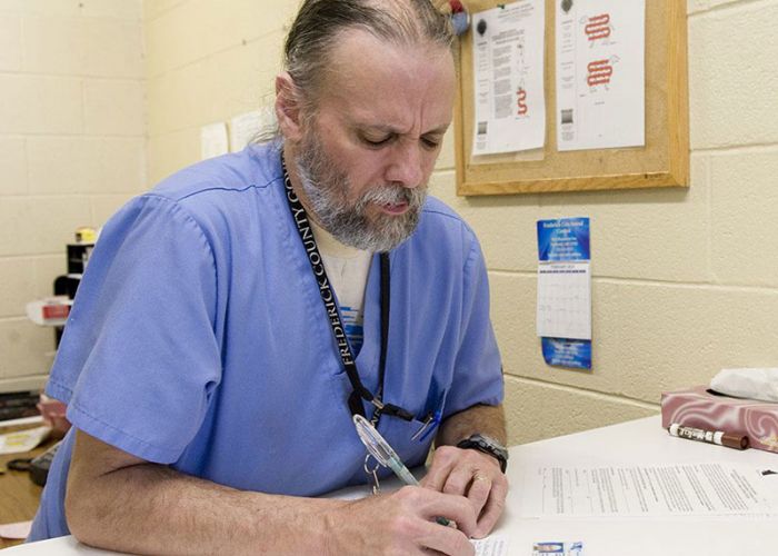 Staff member keeping animal care records